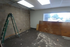 Workers first surveyed wiring and structure before opening up the wall for our new door